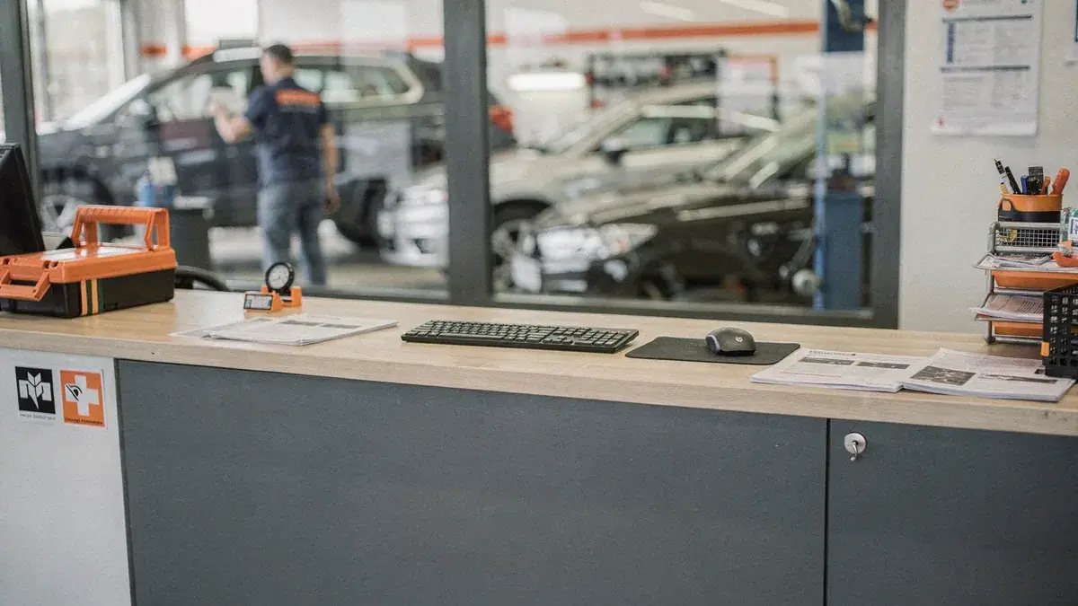 Leerer Empfangstresen in einer Autowerkstatt mit Tastatur und Unterlagen